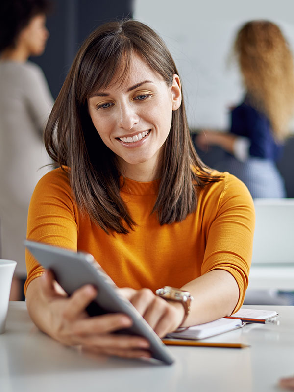 Young woman is talking to his colleague in the office, two women