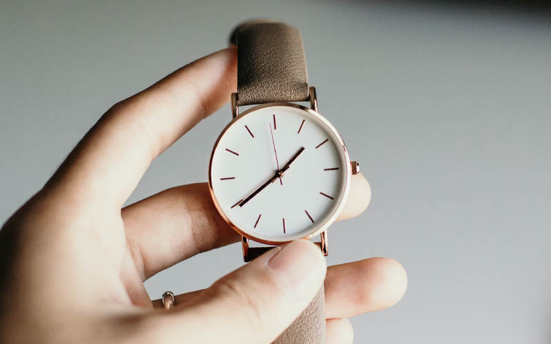 watch in hand to represent the need for effective time management